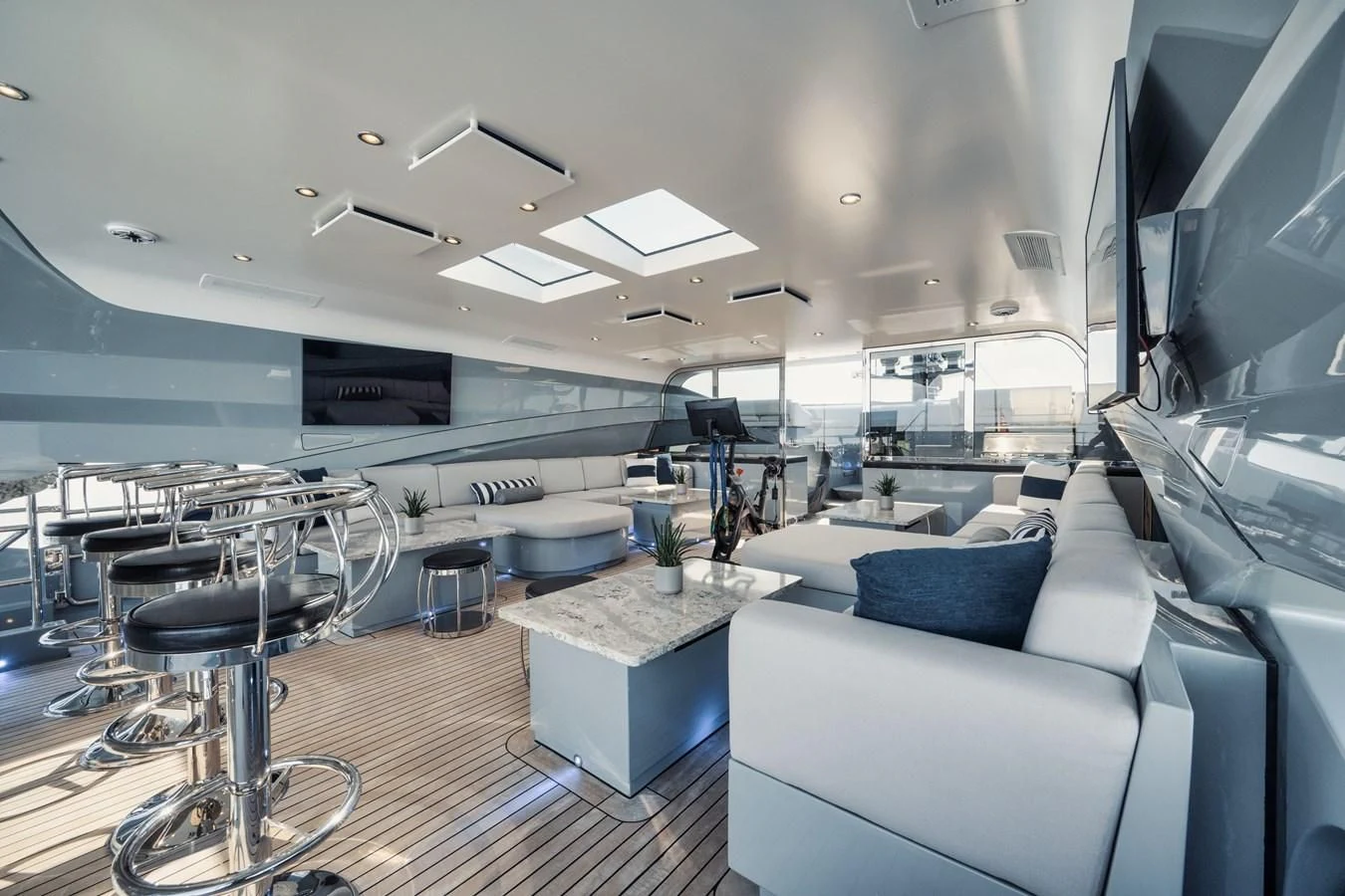 a room with a couch and a table and chairs aboard AQUANOVA Yacht for Sale