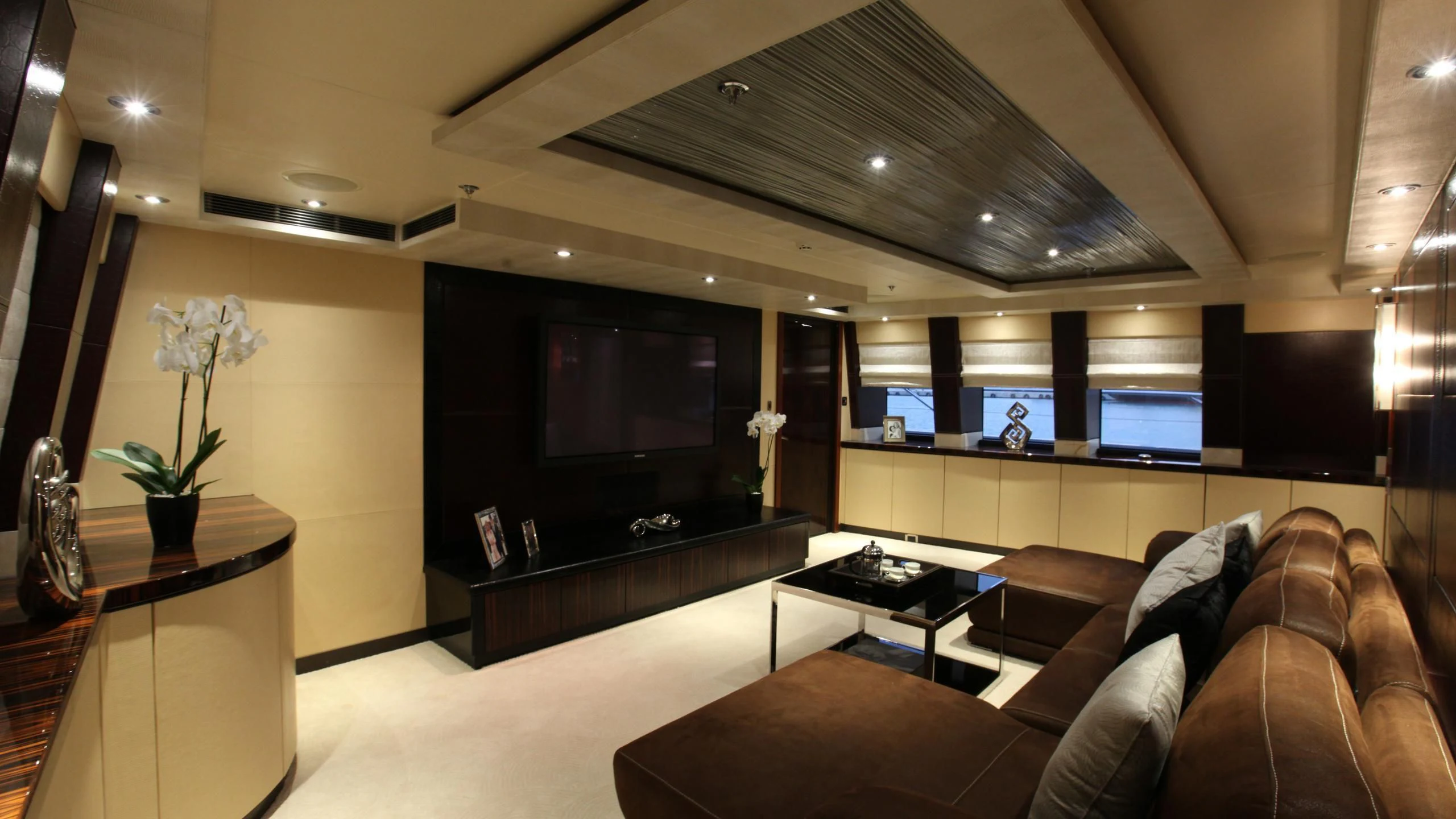 a living room with a large tv aboard AQUANOVA Yacht for Sale