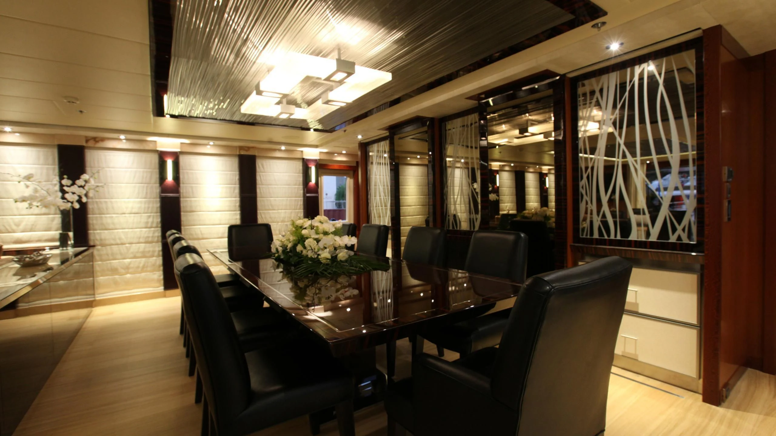 a room with a table and chairs aboard AQUANOVA Yacht for Sale