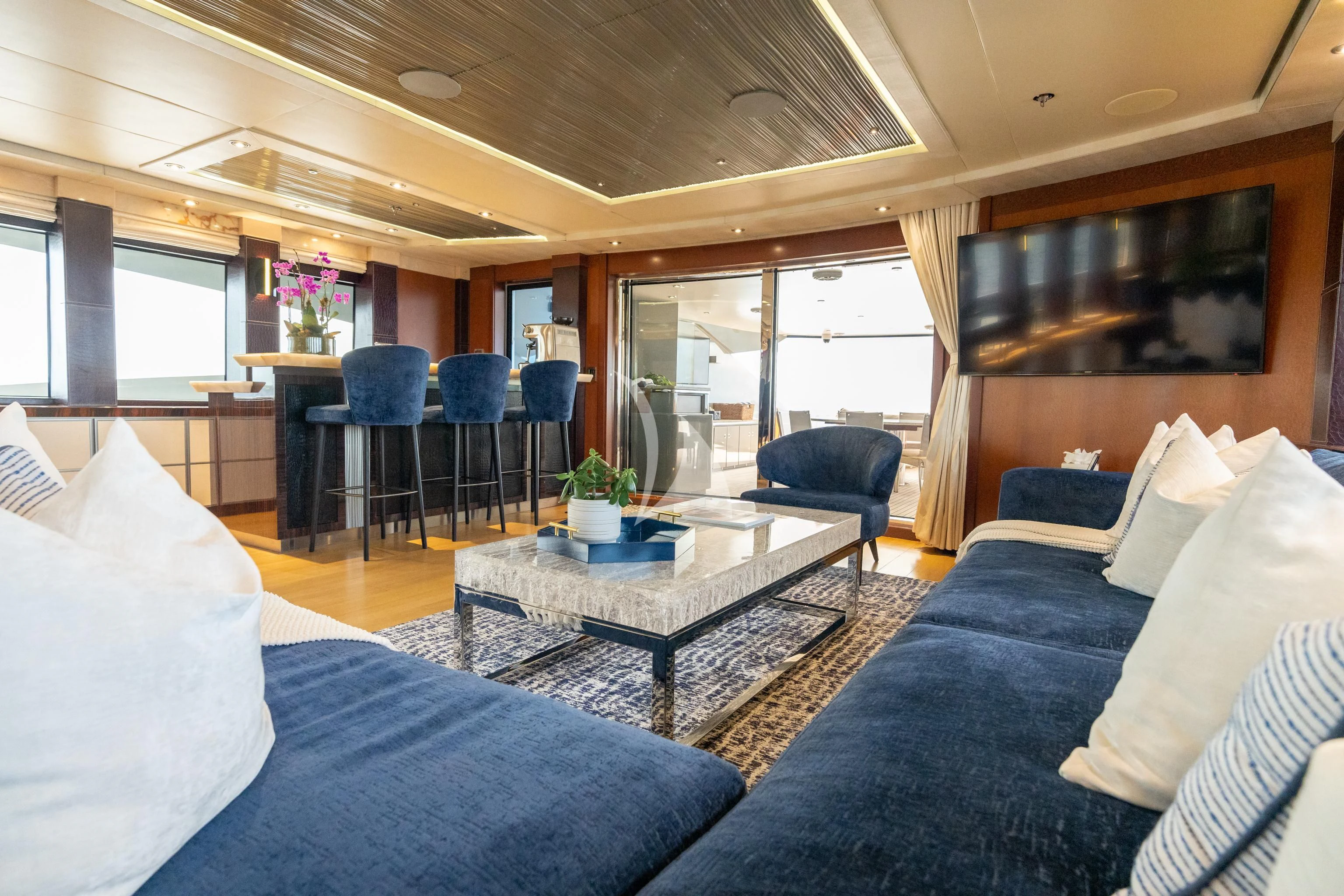 a room with a couch and a table and chairs aboard AQUANOVA Yacht for Sale
