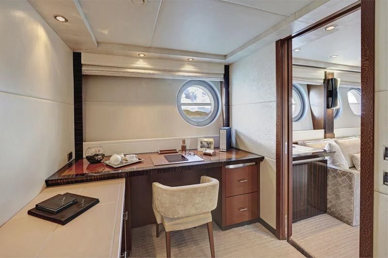 a room with a desk and a bed aboard AQUANOVA Yacht for Sale