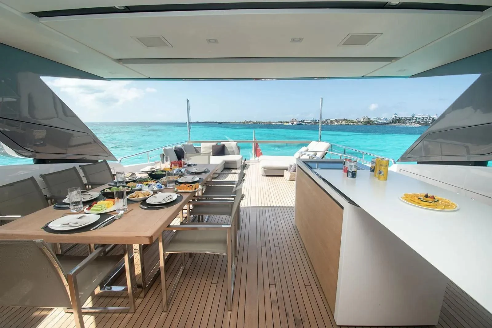 a deck with a table and chairs on it aboard MUMA Yacht for Sale