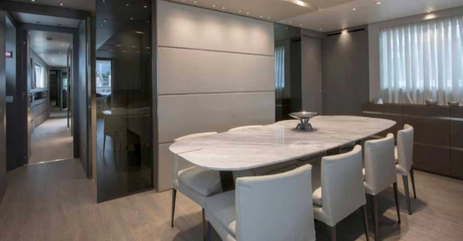 a conference room with a table and chairs aboard MUMA Yacht for Sale