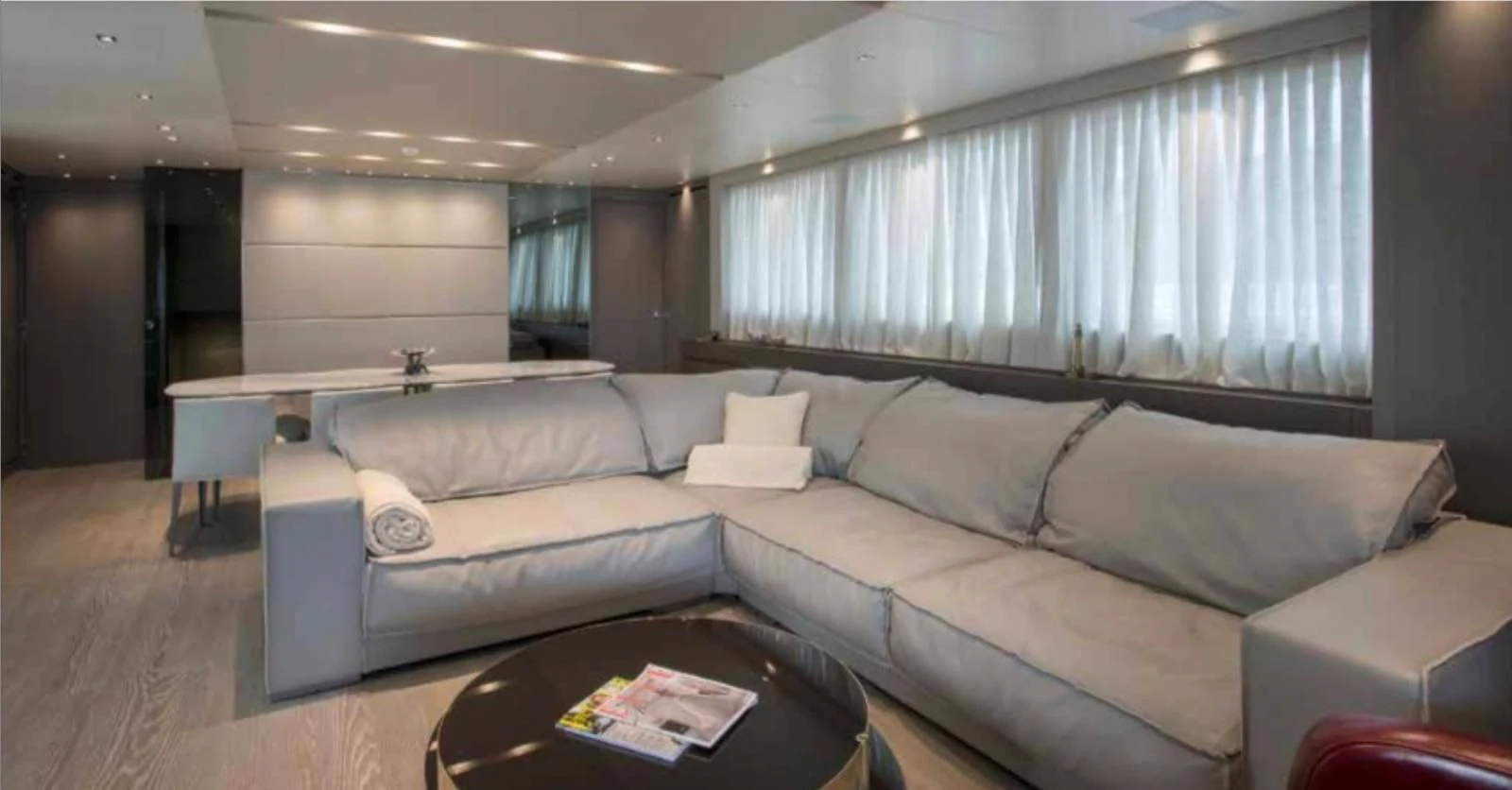 a living room with a couch and a coffee table aboard MUMA Yacht for Sale