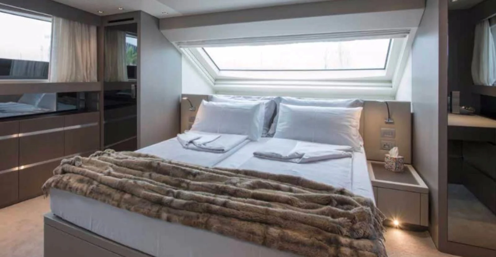 a bed with a white comforter aboard MUMA Yacht for Sale