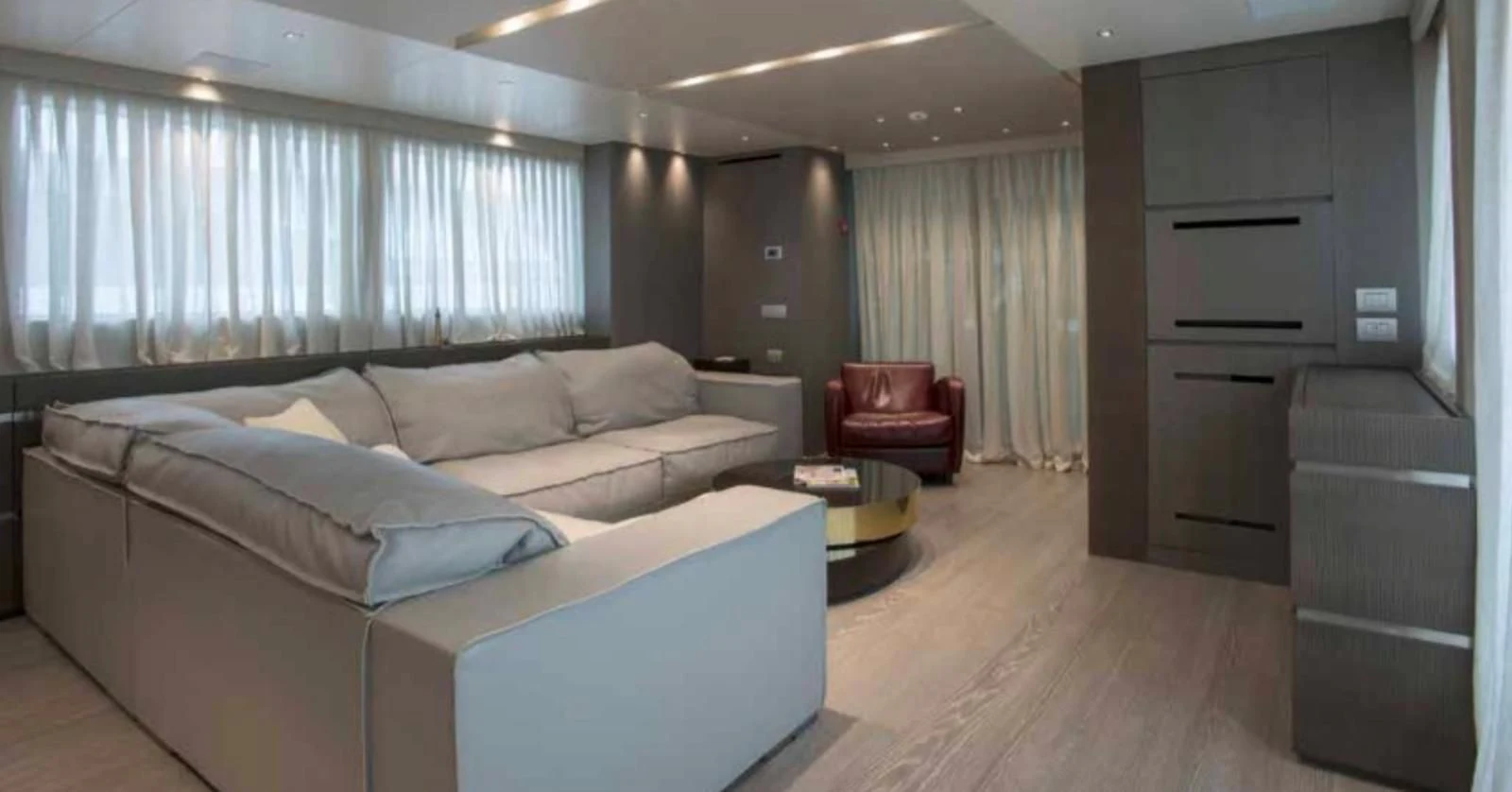 a living room with a couch and a table aboard MUMA Yacht for Sale