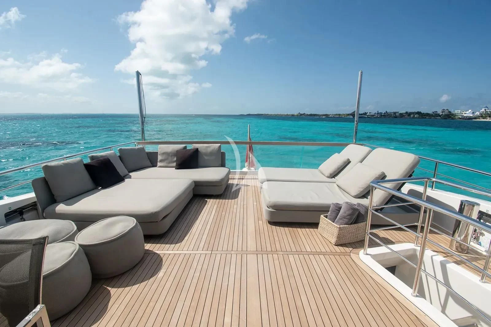 a deck with lounge chairs on it by the water aboard MUMA Yacht for Sale