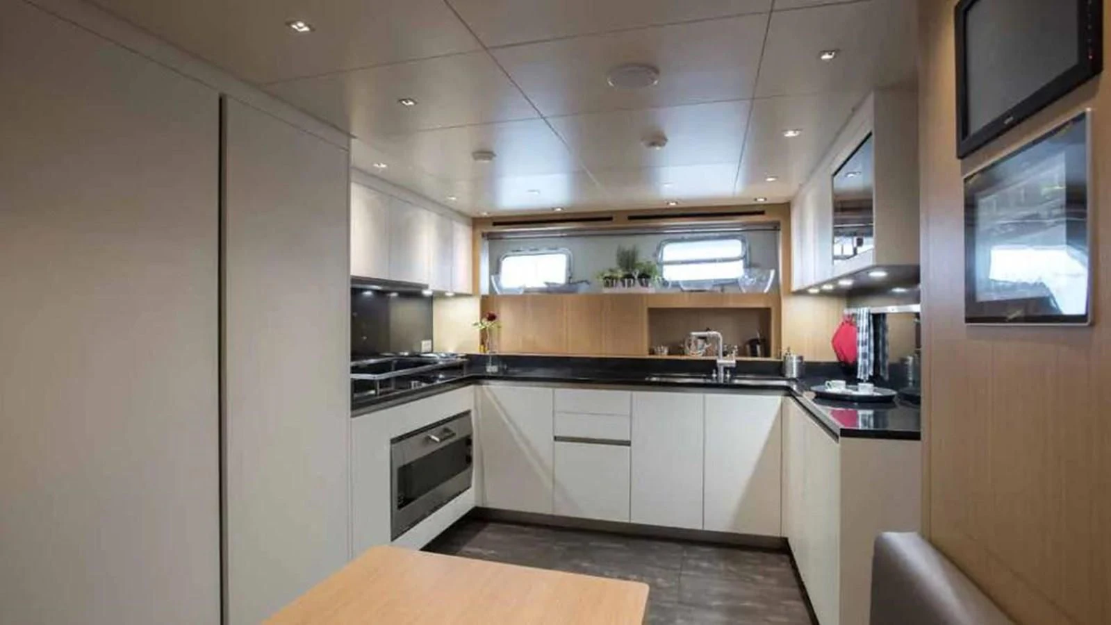 a kitchen with white cabinets aboard MUMA Yacht for Sale