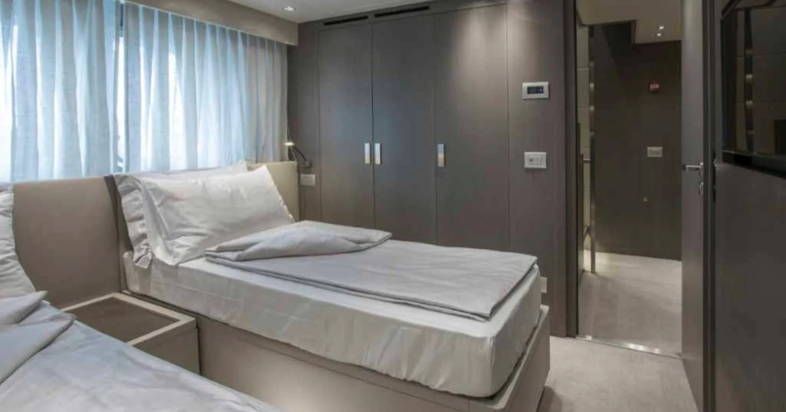 a room with a bed and a door aboard MUMA Yacht for Sale