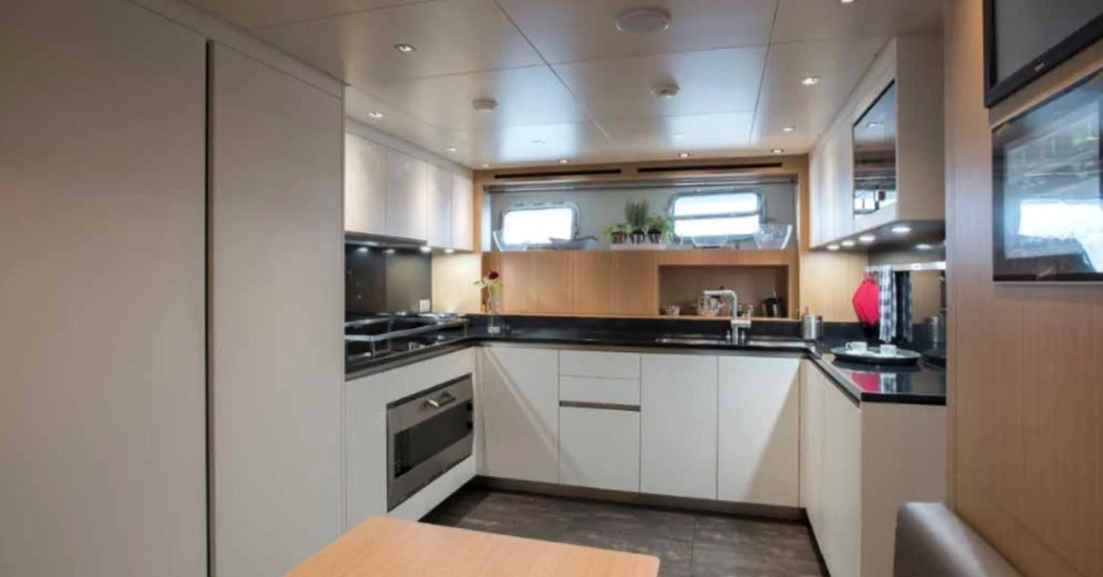 a kitchen with white cabinets aboard MUMA Yacht for Sale