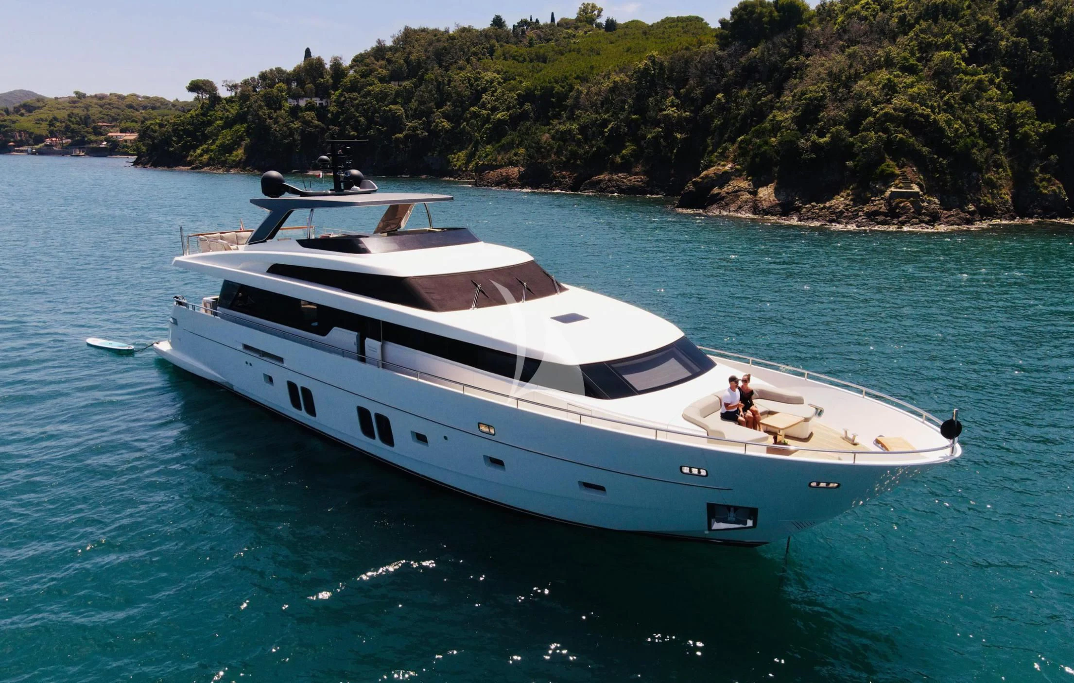 a white boat on the water aboard MUMA Yacht for Sale