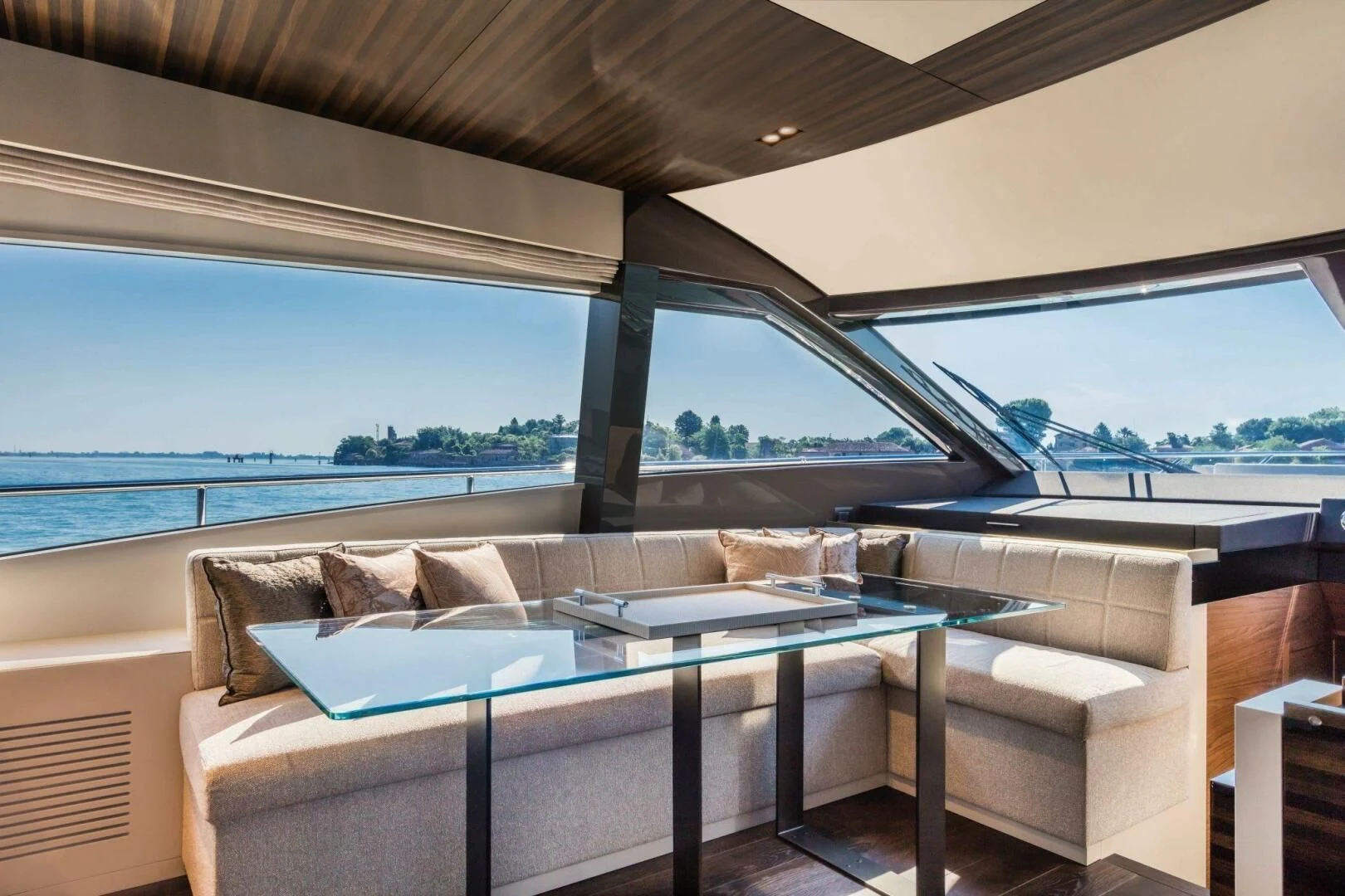 a couch and a table in a room with a large window aboard OUR TRADE Yacht for Sale