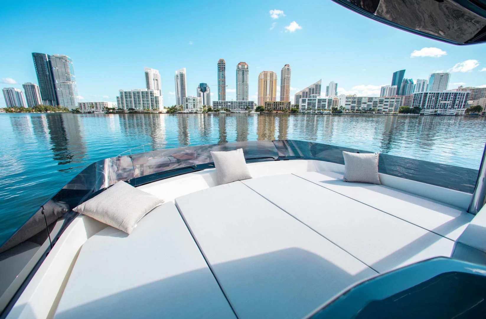 a large white boat in a large body of water with a city in the background aboard OUR TRADE Yacht for Sale