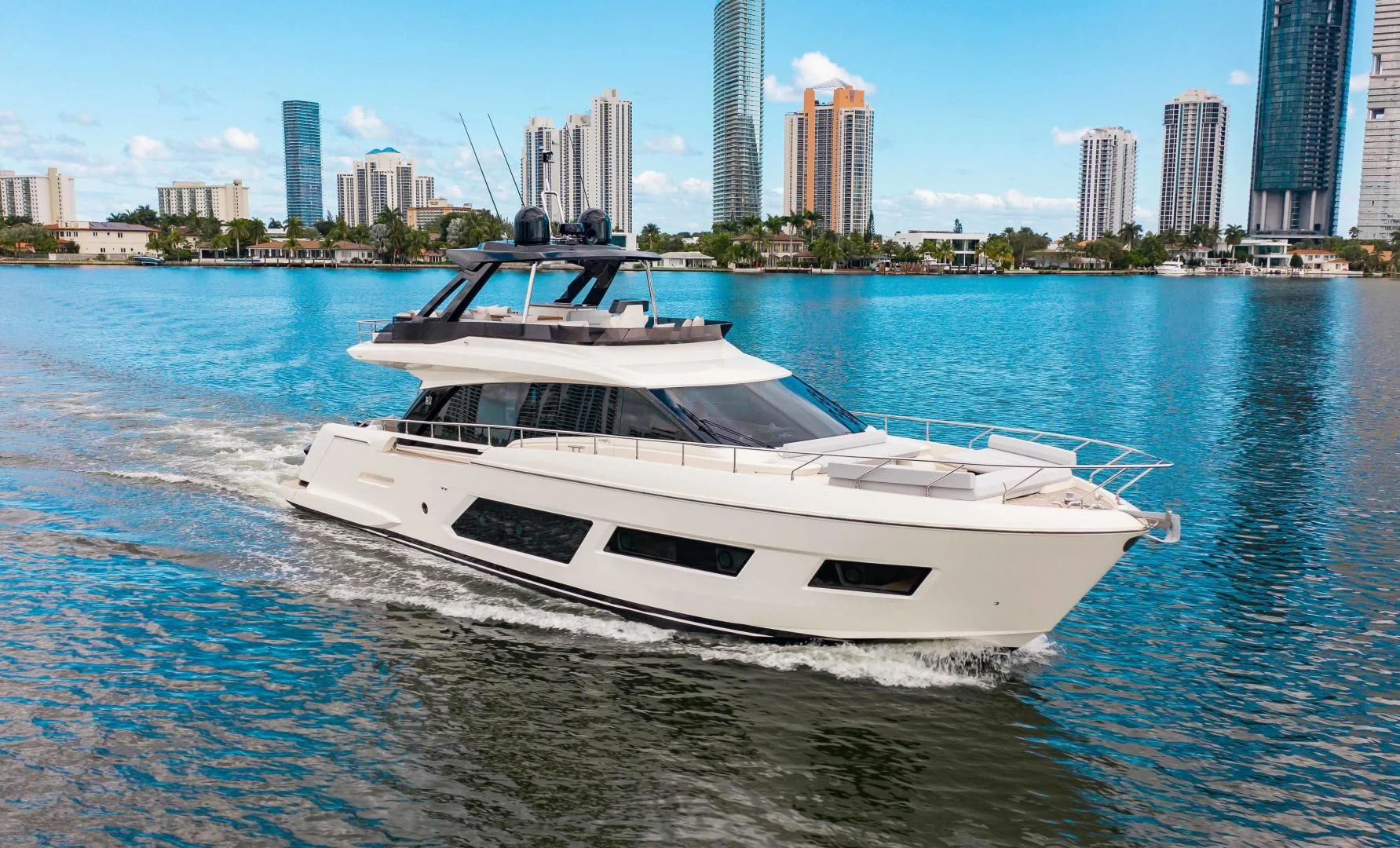 a white yacht on the water aboard OUR TRADE Yacht for Sale