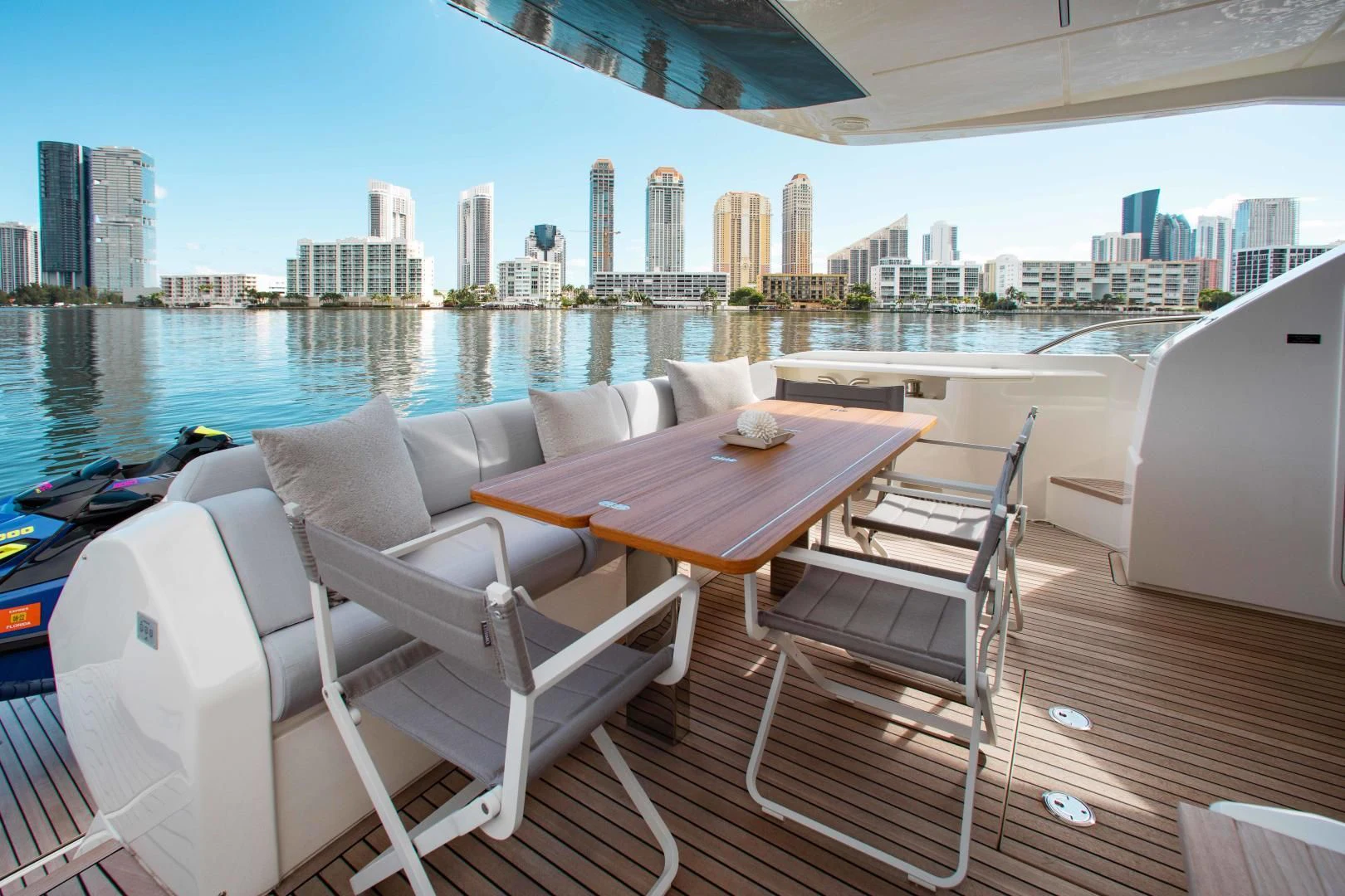a table and chairs on a deck overlooking a city aboard OUR TRADE Yacht for Sale
