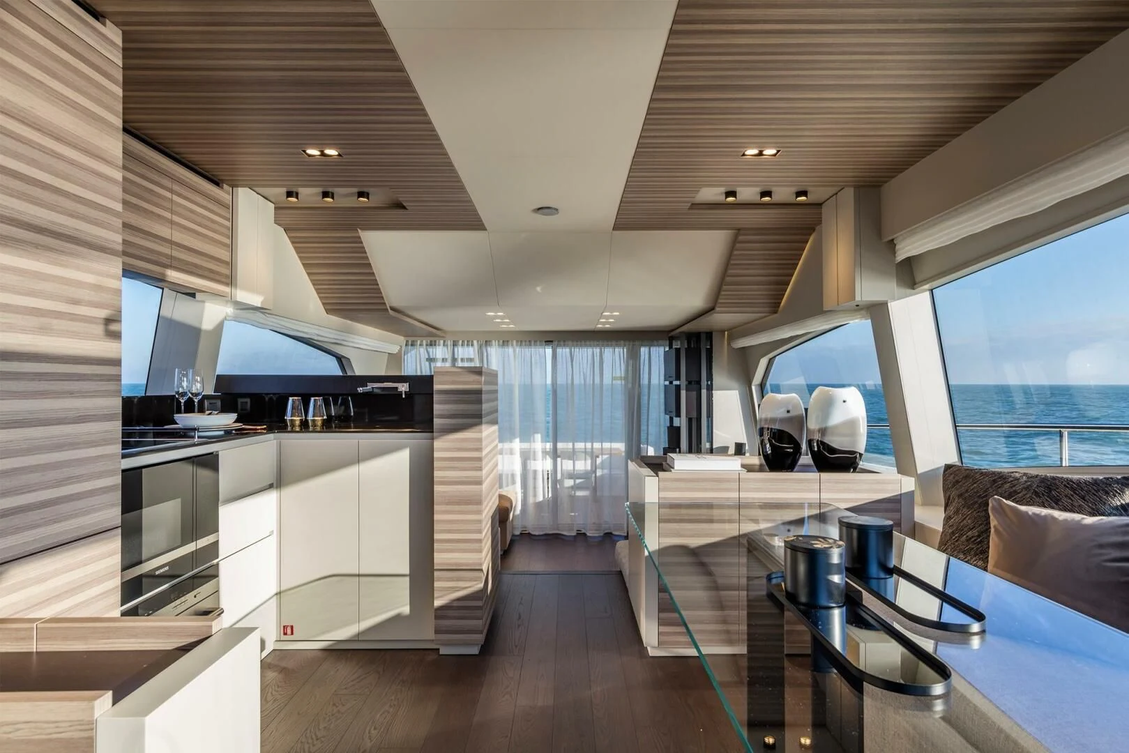 a room with a large window and a table with chairs and a tv aboard OUR TRADE Yacht for Sale