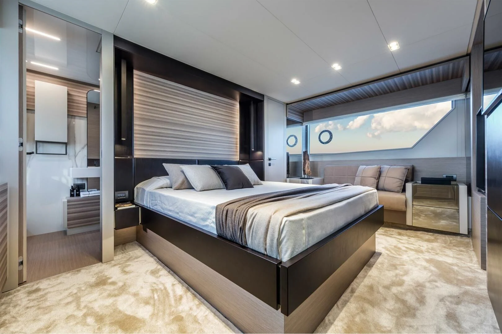 a bedroom with a bed and a couch aboard OUR TRADE Yacht for Sale