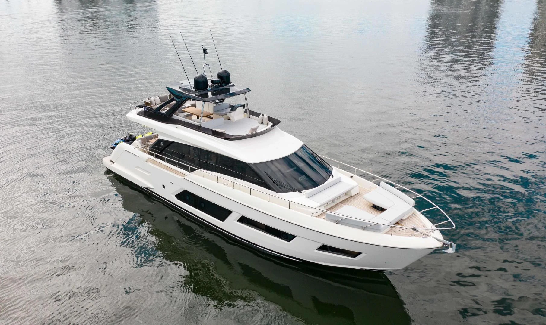 a white boat on the water aboard OUR TRADE Yacht for Sale