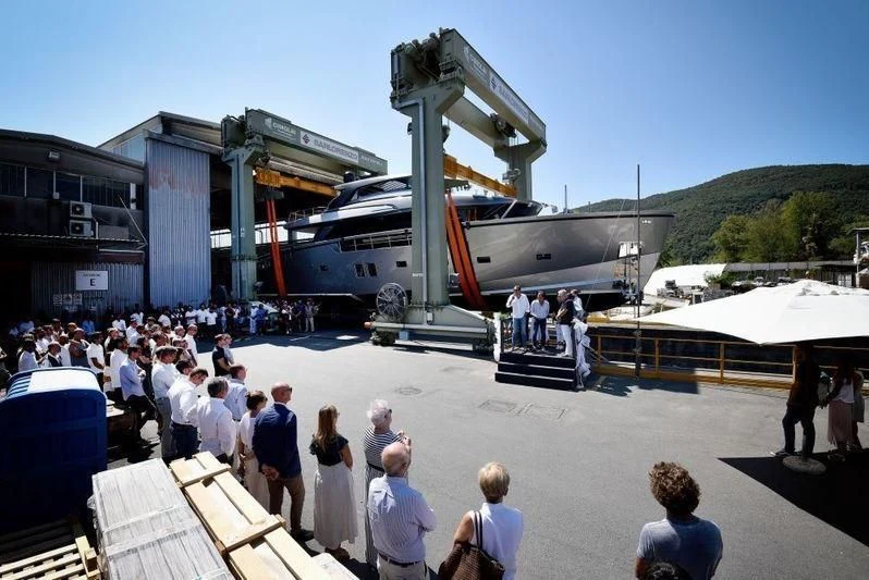 a group of people standing outside a large building with a plane on the roof aboard SANLORENZO SX88/01 Yacht for Sale