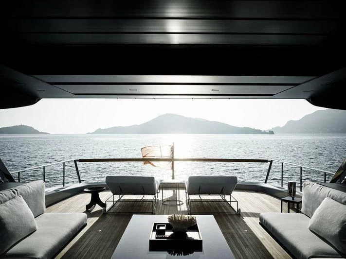 a deck with chairs and a body of water in the background aboard SANLORENZO SX88/01 Yacht for Sale