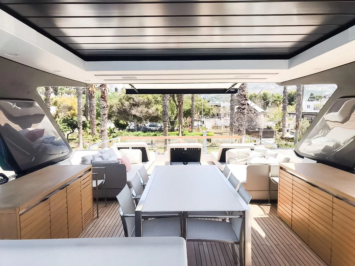 a deck with tables and chairs aboard SANLORENZO SX88/01 Yacht for Sale