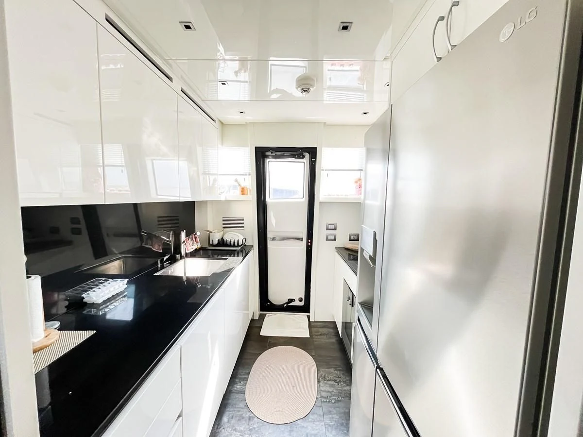a kitchen with white cabinets aboard SANLORENZO SX88/01 Yacht for Sale