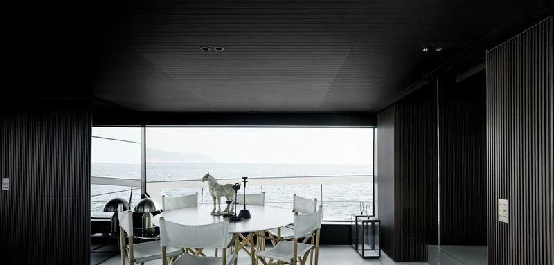 a dog standing on a table in a room with a large window aboard SANLORENZO SX88/01 Yacht for Sale