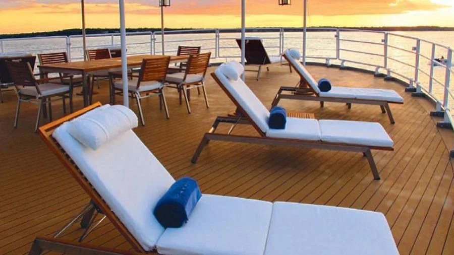 a room with tables and chairs aboard OMNIA Yacht for Sale