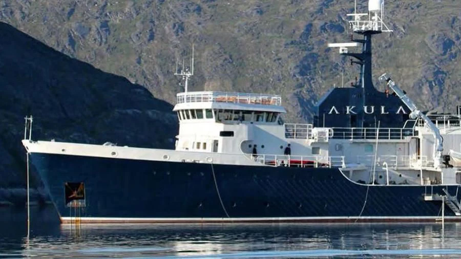 a large white boat with a crane on a dock aboard OMNIA Yacht for Sale