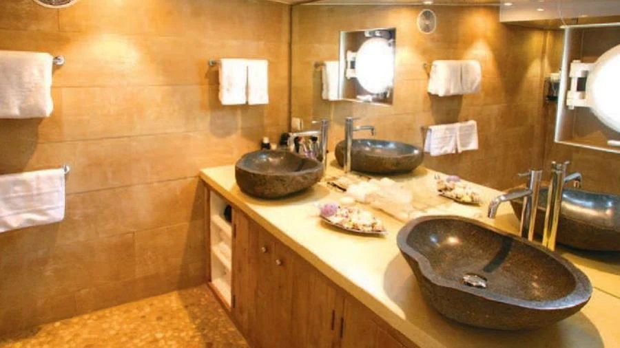a bathroom with a sink and a mirror aboard OMNIA Yacht for Sale