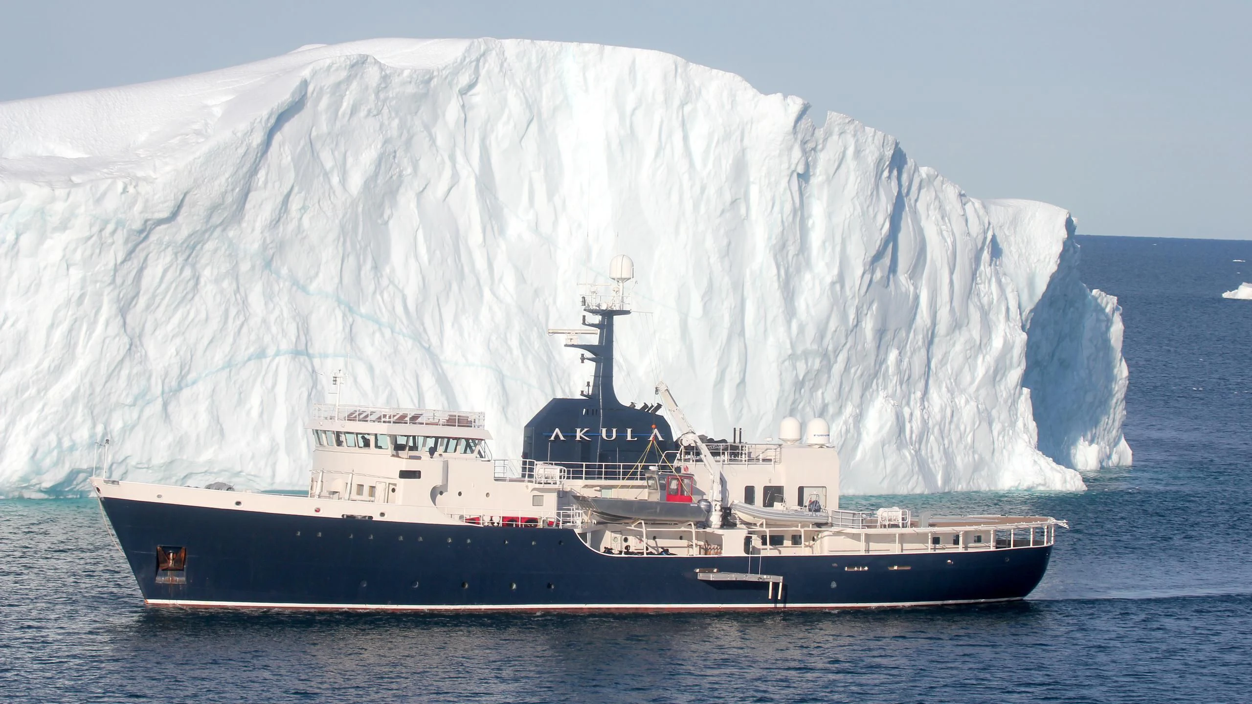 a large ship in front of a large iceberg aboard OMNIA Yacht for Sale