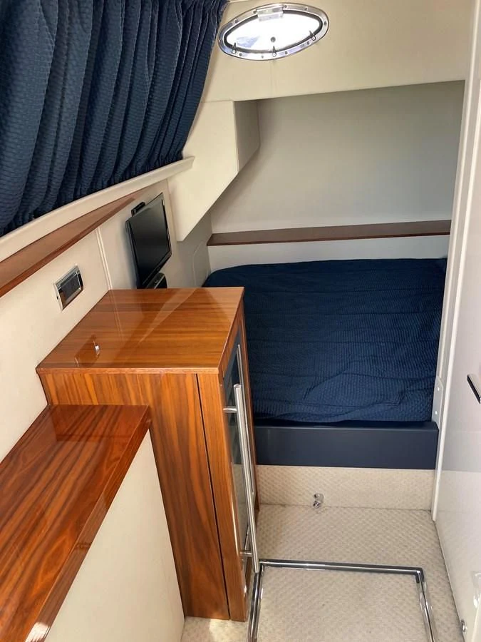 a room with a bed and a desk aboard GRACE ELLEN Yacht for Sale