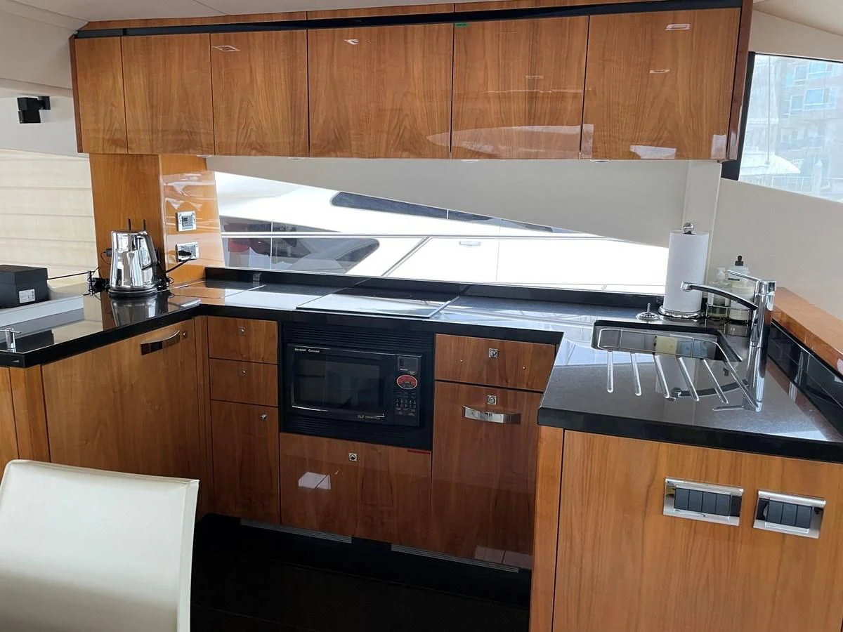 a kitchen with wooden cabinets aboard GRACE ELLEN Yacht for Sale
