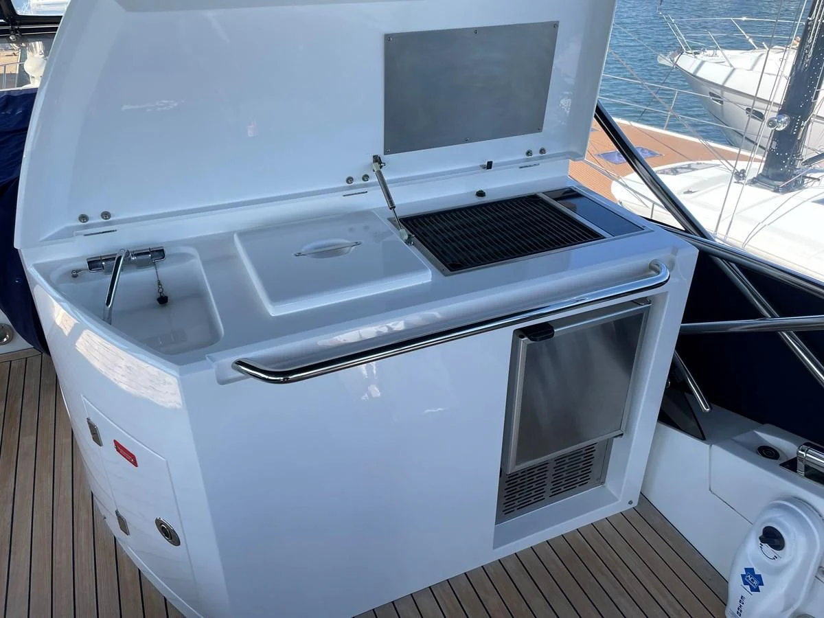a white boat with a black and silver deck and a deck aboard GRACE ELLEN Yacht for Sale