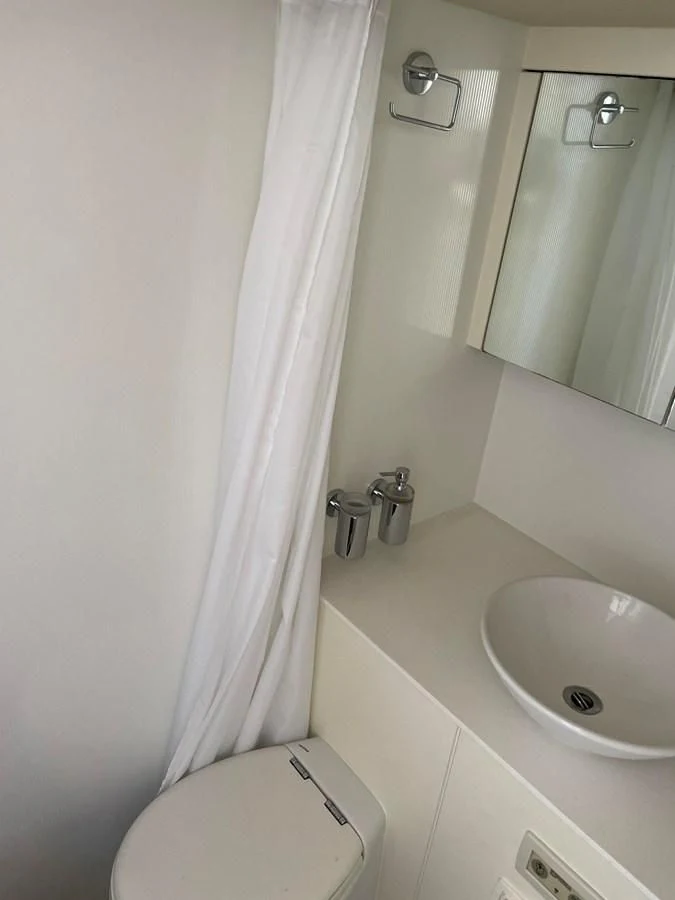 a bathroom with a sink and toilet aboard GRACE ELLEN Yacht for Sale