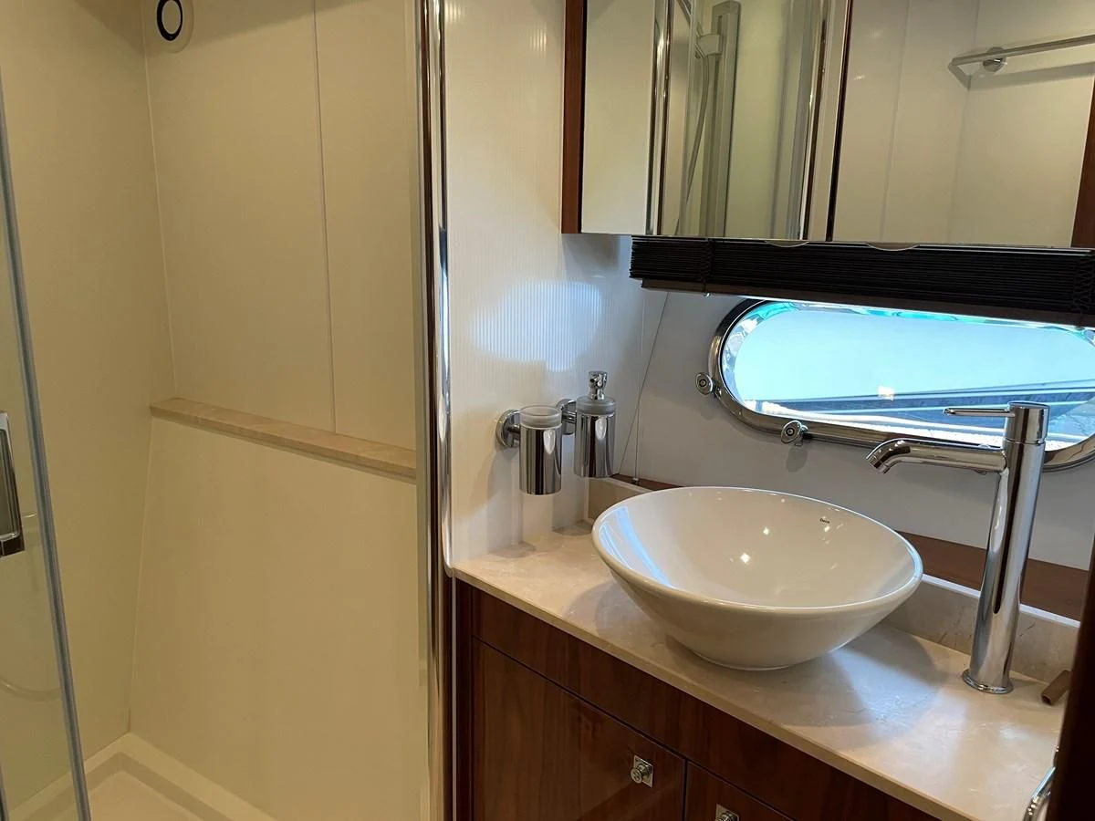a bathroom with a sink and a mirror aboard GRACE ELLEN Yacht for Sale