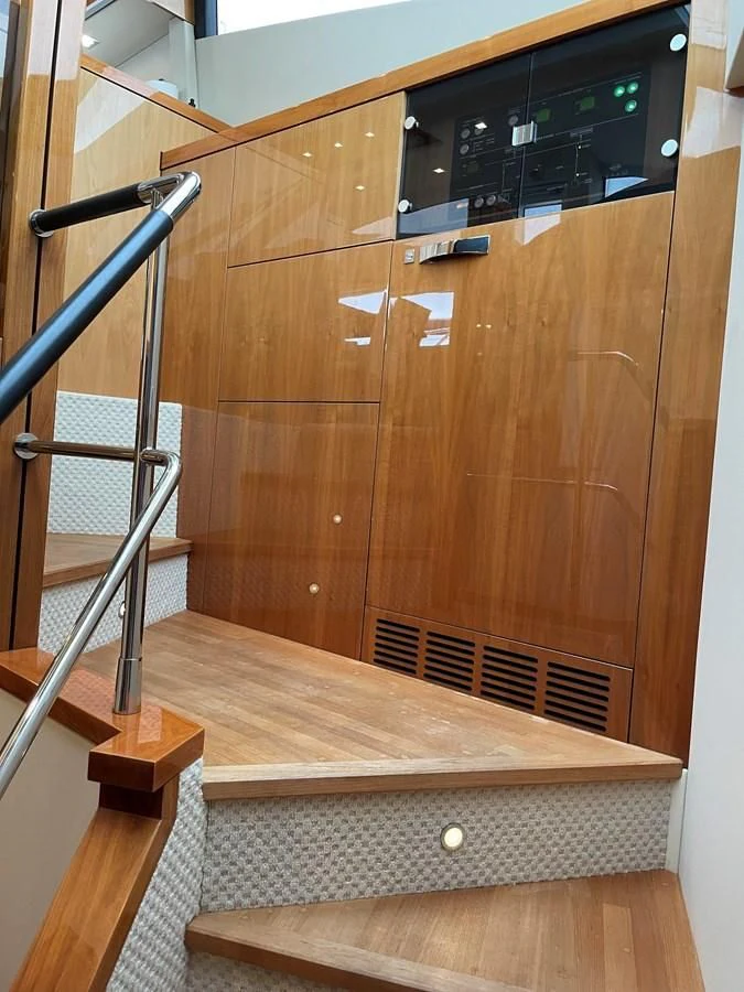 a wooden cabinet with a black radio aboard GRACE ELLEN Yacht for Sale