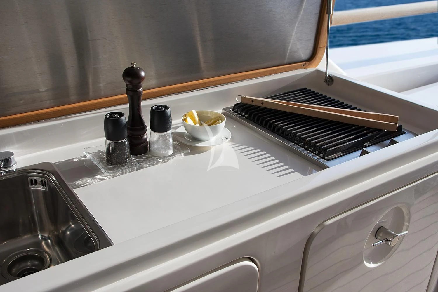 a kitchen sink with a stove and faucet aboard SOURAYA Yacht for Sale