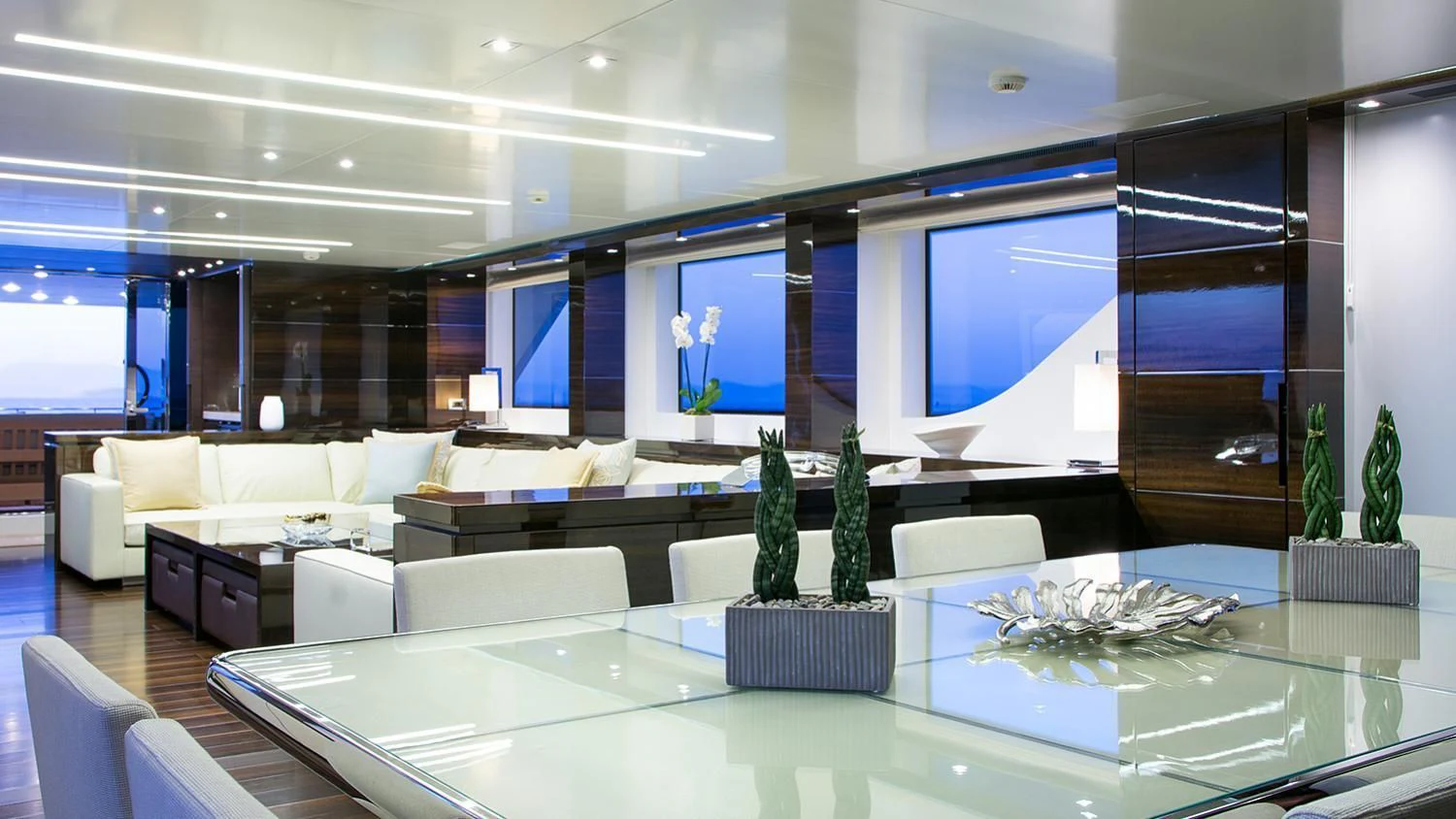a large room with a large table and plants in it aboard SOURAYA Yacht for Sale