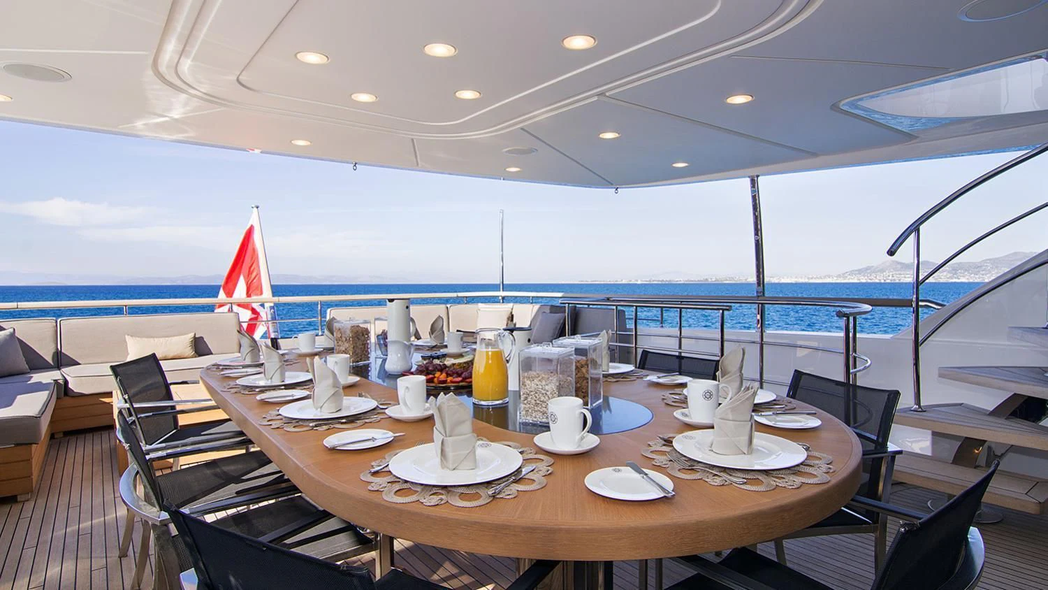 a table with plates and chairs on it aboard SOURAYA Yacht for Sale