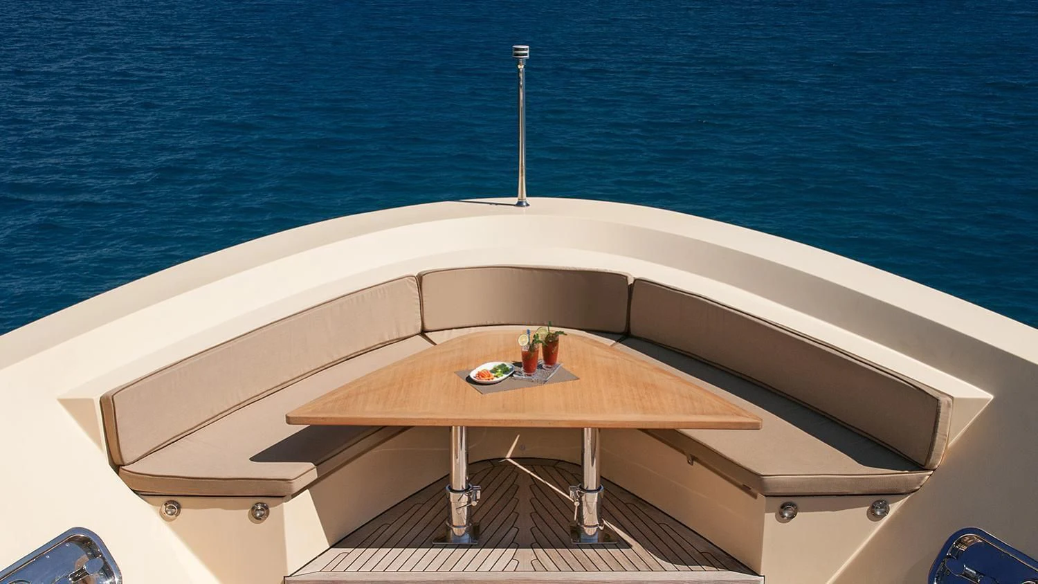 a white rectangular table with a white table and a white pole on a boat with blue water and aboard SOURAYA Yacht for Sale