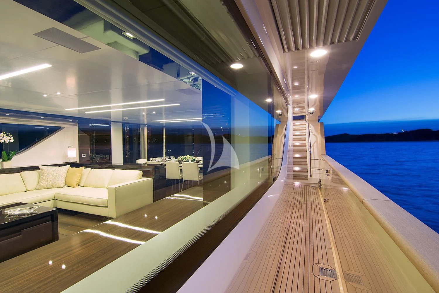 a room with a wood deck and a large window overlooking the water aboard SOURAYA Yacht for Sale