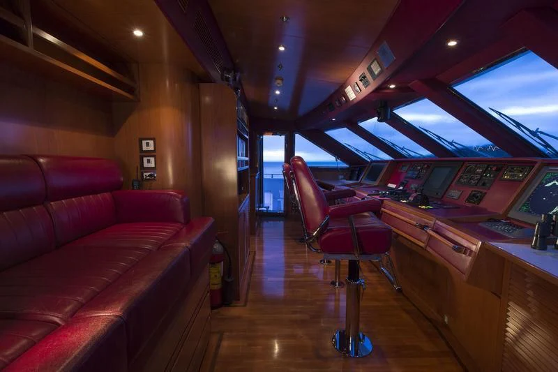 a room with a red chair and a red chair aboard EMERALD (YET) Yacht for Sale
