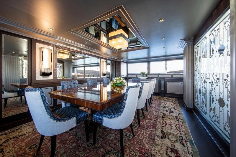 a large dining room with a table and chairs aboard EMERALD (YET) Yacht for Sale