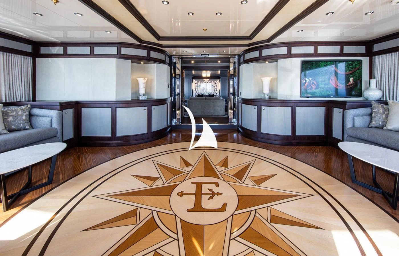 a large living room with a large chandelier aboard EMERALD (YET) Yacht for Sale