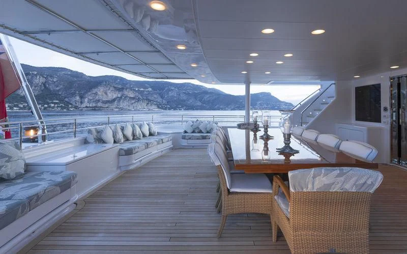 a large lounge area with a large pool and a large deck with a view of the mountains and aboard EMERALD (YET) Yacht for Sale