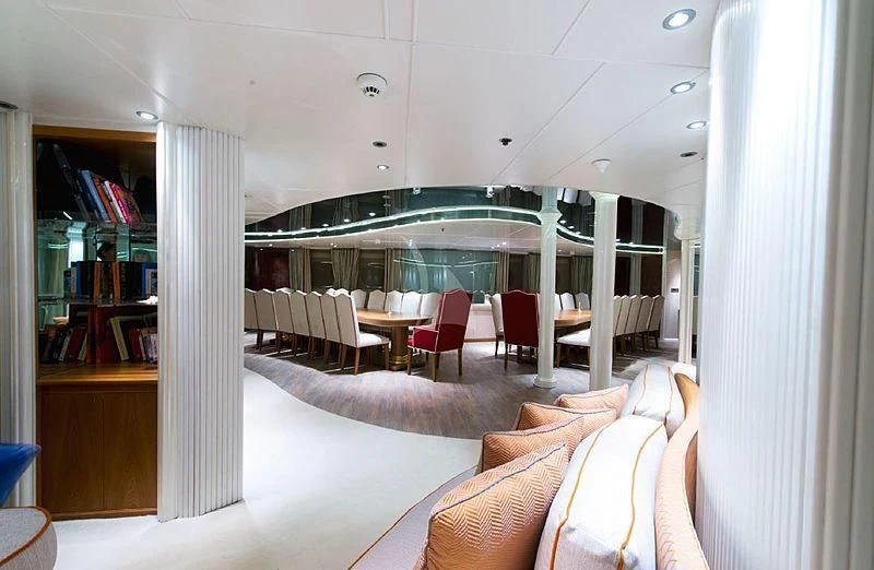a room with a couch and a table and chairs aboard ELEGANT 007 Yacht for Sale