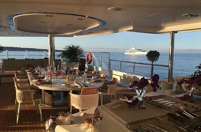 a room with tables and chairs aboard ELEGANT 007 Yacht for Sale