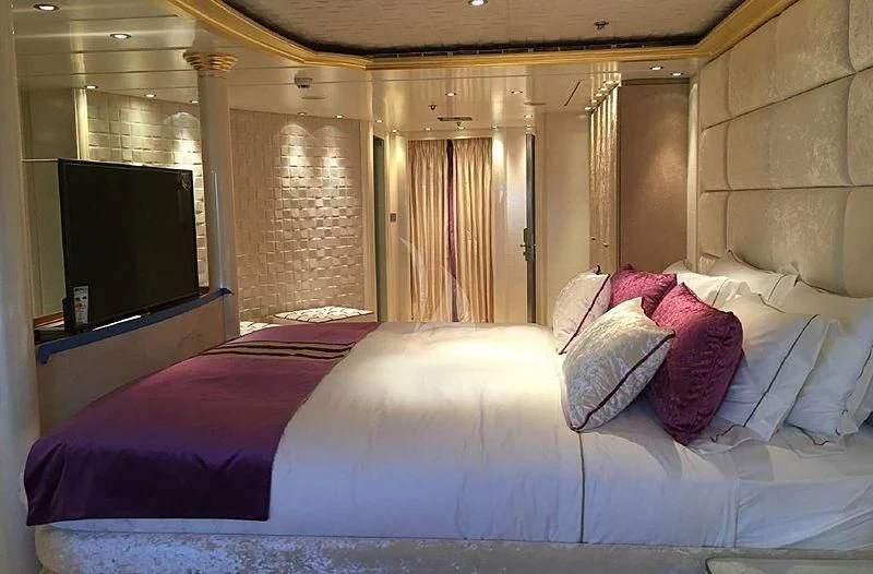 a bed with purple sheets aboard ELEGANT 007 Yacht for Sale