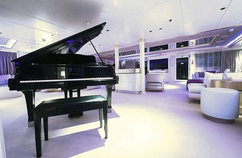 a black and white piano in a room with a large window aboard ELEGANT 007 Yacht for Sale